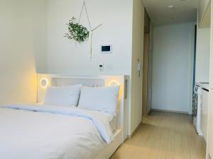 Postel nebo postele na pokoji v ubytování OceanStay E7 INN-TheCity