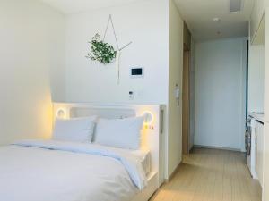 Postel nebo postele na pokoji v ubytování OceanStay E7 INN-TheCity