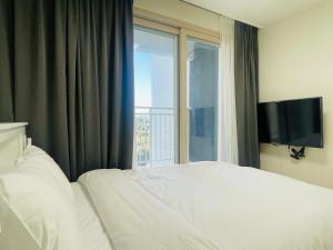 Postel nebo postele na pokoji v ubytování OceanStay E7 INN-TheCity