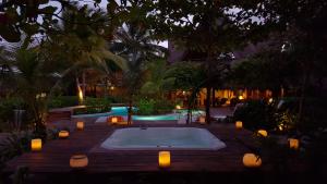 a swimming pool with a hot tub in a backyard at The Beach Tulum Hotel in Tulum
