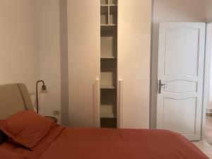 a bedroom with a bed and a white door at S2 La Marsa Plage in La Marsa