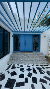 a house with a blue door and a checkered floor at Moon mountain resort in Sharm