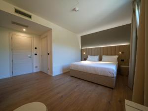 a bedroom with a large bed and a bathroom at Castiglioncello Suite in Castiglioncello