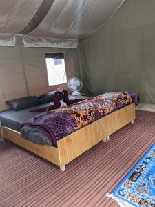 a bed in a tent with a teddy bear on it at Soma Caves Tents in Jagatsukh