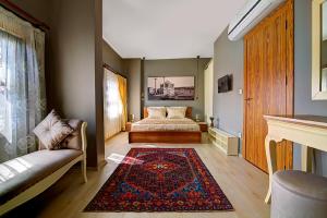 a bedroom with a bed and a couch and a rug at Million Old City Apartment in Istanbul