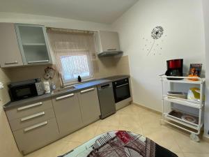 a small kitchen with a sink and a microwave at Apartman Sweet Garden K&A in Zagreb