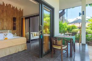 a bedroom with a bed and a table and a table and chairs at Villa Mahkai in Ambengan +46 photos