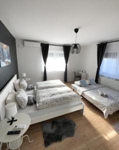 a bedroom with two beds and a desk and a table at 4 STARS APARTMENTS Near Airport in Velika Gorica