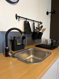a kitchen counter with a sink and some dishes at 4 STARS APARTMENTS Near Airport in Velika Gorica