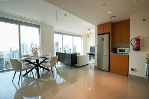 a kitchen with a table and chairs in a kitchen at Luxurious 1BR in Opera Grand 5 mins walk to Burj Khalifa in Dubai