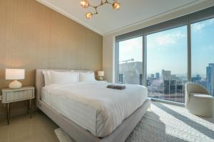 a bedroom with a large bed and a large window at Luxurious 1BR in Opera Grand 5 mins walk to Burj Khalifa in Dubai +18 photos