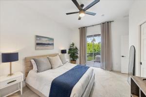 a bedroom with a bed and a ceiling fan at Charlotte County Villa 5878: Waterfront Pool Spa Home in Punta Gorda +44 photos
