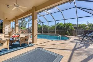 a patio with a table and chairs and a pool at Cape Coral Villa 1001: Private Pool Tranquil Stay in Matlacha