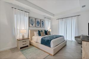 Schlafzimmer mit einem Bett, einer Kommode und Fenstern in der Unterkunft Charlotte County 5886: Perfect Gulf Coast Retreat in Port Charlotte