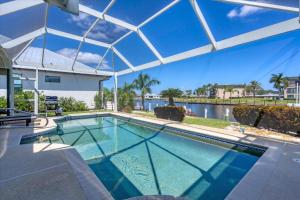 a swimming pool in a house with a view of the water at Charlotte County Villa 5893: Your Perfect Getaway in Punta Gorda