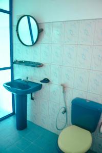 a bathroom with a sink and a toilet and a mirror at Glow Accommadation in Tangalle +47 photos