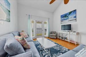 a living room with a couch and a tv at Charlotte County Condo 5910 - Serenity by the River in North Port
