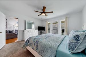 a bedroom with a bed and a ceiling fan at Charlotte County Condo 5910 - Serenity by the River in North Port +35 photos