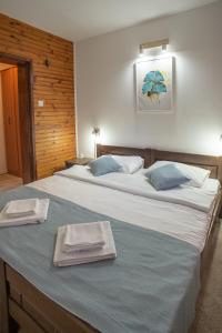 A bed or beds in a room at MB Hotel