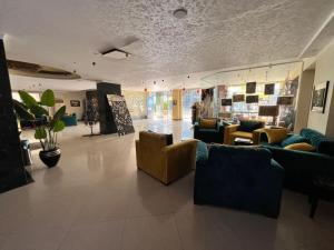 a lobby with couches and chairs in a store at Sea Life Apartments-hotel in Hurghada