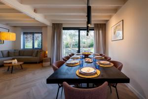 ein Esszimmer mit Tisch und Stühlen in der Unterkunft Groenendijk Verhuur Vakantiehuis Jonas Burgh-Haamstede in Burgh Haamstede