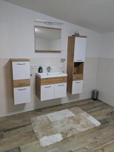 a bathroom with a sink and a mirror at Kettis Apartment in Gröbming +11 photos