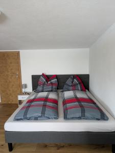 a bed with two pillows on it in a room at Kettis Apartment in Gröbming +5 photos