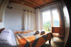 Postel nebo postele na pokoji v ubytování Paradise Point Nature Cabana Kandy