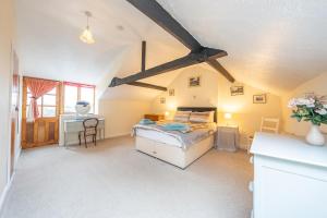 a bedroom with a bed and a desk at The Coach House in Abergavenny