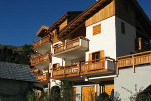 a large white building with wooden balconies at Chalet de l'Orceyrette in Briançon