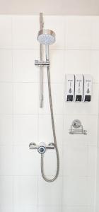 a shower in a white tiled bathroom at Russel House - 4 Bedroom - The Royal Mile in Edinburgh +36 photos