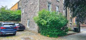 a blue car parked in front of a brick building at Russel House - 4 Bedroom - The Royal Mile in Edinburgh