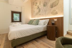 ein Schlafzimmer mit einem großen Bett mit weißer Bettwäsche in der Unterkunft Lumamè Resort B&B in Montefiore Conca