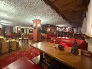 a living room with a red couch and a table at Hotel Breuil in Breuil-Cervinia