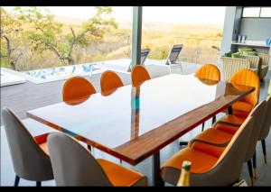 a conference room with a white table and chairs at La-Ngwenya Serenite in Warmbaths