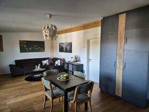 a living room with a table and chairs and a couch at Ferienwohnung Mariposa in Böbing