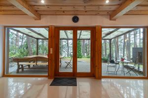 a screened in porch with sliding glass doors at Villa Green in Molėtai