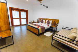 a large bedroom with a bed and a couch at Ayuwaters Authentic Yoga and Ayurveda Retreat by the Bentota River All Inclusive in Bentota +37 photos