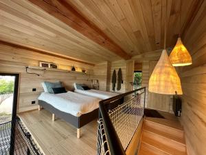 a bedroom with a bed in a wooden room at O'Chambon in Chambon-sur-Lac