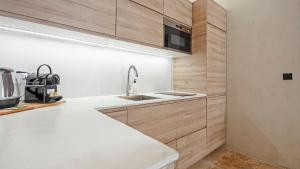 a kitchen with a sink and a counter at Luxueux appartement avec terrase sur la mer in Grimaud