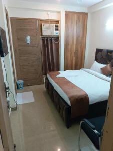 Postel nebo postele na pokoji v ubytování Soooper Hotel