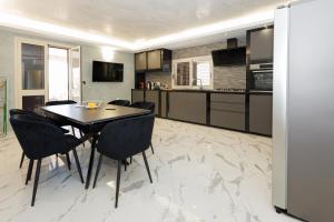 a kitchen with a table and chairs in a room at Villa Caruso in Avola