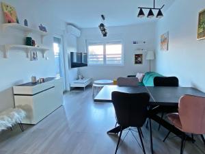 a living room with a dining table and a kitchen at Bubble in Trogir