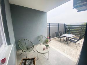 a balcony with chairs and a table and a table and chairs at Bubble in Trogir