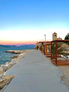 a pathway next to the water with a church at Bubble in Trogir
