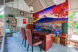 a room with a large painting on the wall at Tani Ryu River Kwai in Ban Tha Pong (1)