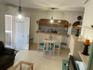 a kitchen and a living room with a table and chairs at CASA BEDAMA in Orihuela