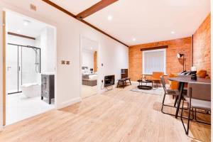 a living room with a table and a dining room at Stunning 2 Bed Apartment in Burton-on-Trent in Burton upon Trent