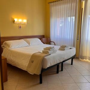 a bedroom with a bed with towels on it at La Casa di Nazareth in Rome +30 photos