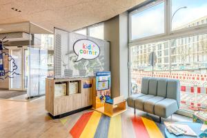 a waiting area at a toy store with a chair and a big window at a&o Hamburg Hauptbahnhof in Hamburg